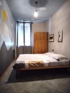 a bedroom with a large bed with a window at Soggiorno Manu in Cantù