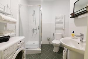 a bathroom with a shower and a toilet and a sink at COMFORT AND HISTORY in Tbilisi City