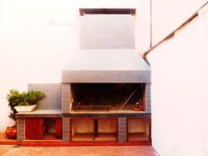 an outdoor pizza oven in a white room with at LA BIANCA in San Salvador de Jujuy