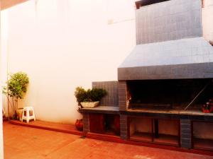 a large brick oven in a room with plants at LA BIANCA in San Salvador de Jujuy