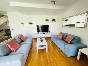 - un salon avec deux canapés bleus et une télévision dans l'établissement Tenerife Family Home, à Santa Úrsula