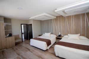 Postel nebo postele na pokoji v ubytování Hotel Sirari By Regina