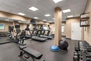 a gym with several treadmills and exercise bikes at Holiday Inn Express Hotel & Suites Fort Pierce West by IHG in Fort Pierce