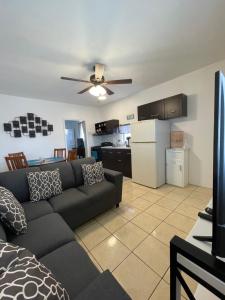 a living room with a couch and a kitchen at Seaside Adventure Lodging in Ensenada
