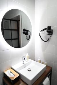 a bathroom with a sink and a mirror at 6/4 de Lamego in Lamego