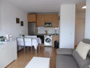 a kitchen and living room with a couch and a table at Santiago in Hendaye