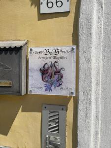 a sign on the side of a building with an octopus on it at Lorenzo il Magnifico in Celano