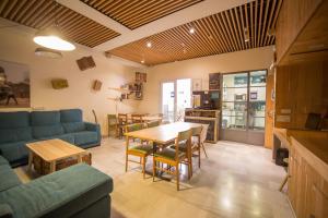 a living room with a blue couch and a table at The Nomad Hostel&Pension in Seville