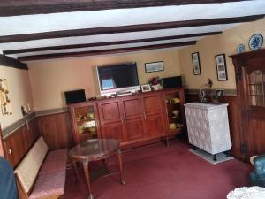 a living room with a tv and a table at Ferienhaus Stahlberg in Bacharach +22 photos