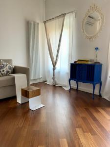 a living room with a blue table and a couch at La Rocca Luxury Apartment in Parma