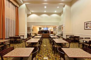 a dining room filled with tables and chairs at Holiday Inn Express Hotel & Suites Twentynine Palms, an IHG Hotel in Twentynine Palms