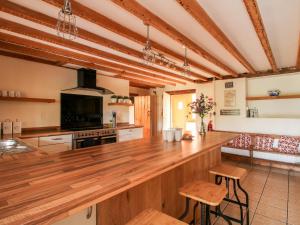 a large kitchen with a large wooden counter top at The Old Farmhouse in Craven Arms
