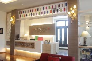 a store lobby with a sign that reads powers pharmacy at Fomecs Boutique Hotel in Melaka