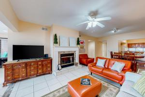 a living room with a couch and a fireplace at Palm Beach Club #126 in Pensacola Beach