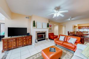 Una sala de estar con un sofá y una chimenea. en Palm Beach Club #126, en Pensacola Beach