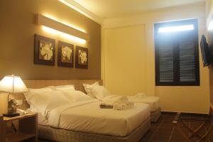 Postel nebo postele na pokoji v ubytování Fomecs Boutique Hotel, Jonker Street