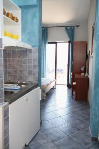 a kitchen with white cabinets and a tile floor at Apartments by the sea Pisak, Omis - 1070 in Mimice +59 photos
