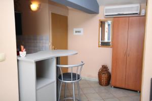 a small kitchen with a counter and a stool at Apartment Pisak 1070e in Mimice