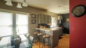 a kitchen with a counter and a clock on the wall at 160inch Home Movie Theater- Great for movie night! in Omaha