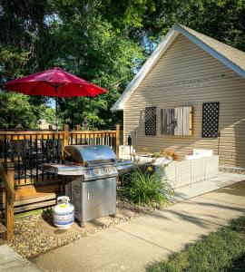 a grill with a picnic table and a house at 160inch Home Movie Theater- Great for movie night! in Omaha