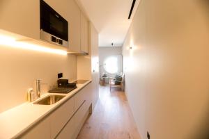 a kitchen with a sink and a counter top at Alegria Suítes By Porto City Hosts in Porto