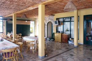 a dining room with tables and chairs and a tv at Apartment Sucuraj 4029e in Sućuraj