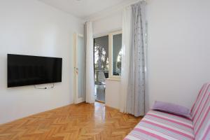 a living room with a flat screen tv on a wall at Apartment Balica Rat 1065a in Tice