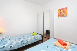 a bedroom with two beds and a mirror at Apartment Balica Rat 1065a in Tice