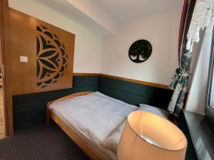 A bed or beds in a room at Domek pod Tatrami