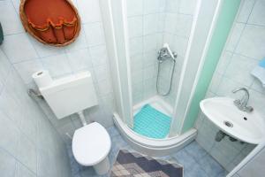 y baño con ducha, aseo y lavamanos. en Apartments by the sea Arbanija, Ciovo - 1085 en Trogir