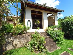 a house with stairs leading to the front door at Casa Morada das Flores in Areia