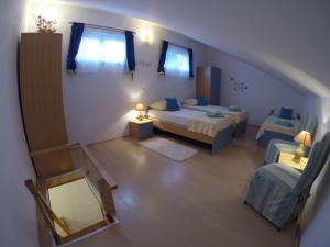 an overhead view of a bedroom with two beds and a mirror at Apartments by the sea Slatine, Ciovo - 1098 in Slatine