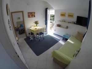 a living room with a couch and a table at Apartments by the sea Slatine, Ciovo - 1098 in Slatine