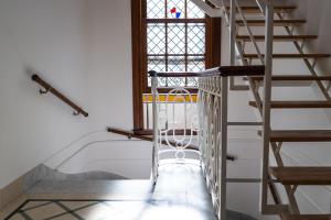 a spiral staircase in a room with a window at Planta Alta Bed & Breakfast in Buenos Aires