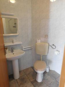 a bathroom with a toilet and a sink at Apartment Slatine 1128a in Slatine
