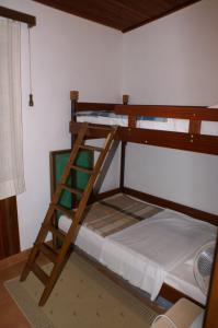 a bunk bed in a room with a ladder at Apartments by the sea Vinisce, Trogir - 1166 in Vinišće