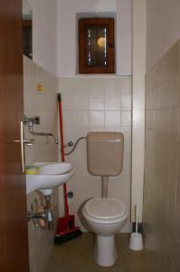 a bathroom with a toilet and a sink at Apartments by the sea Vinisce, Trogir - 1166 in Vinišće