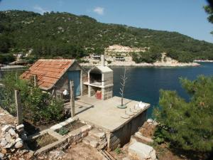 a small house on a dock in the water at Seaside secluded apartments Cove Srhov Dolac, Hvar - 2072 in Gdinj