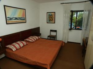 a bedroom with a bed with two pillows on it at Seaside secluded apartments Cove Srhov Dolac, Hvar - 2072 in Gdinj