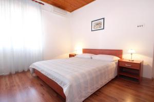 a bedroom with a large bed and a window at Double Room Mandre 3557b in Kolan