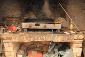 an old stove sitting on top of a stone fireplace at Double Room Mandre 3557a in Kolan
