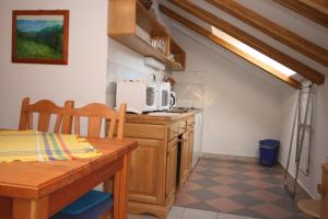 a small kitchen with a table and a microwave at Apartments and rooms by the sea Slano, Dubrovnik - 2178 in Slano +39 photos