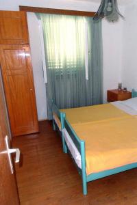 a bedroom with a bed and a door and a window at Apartments with a parking space Vrisnik, Hvar - 4051 in Jelsa