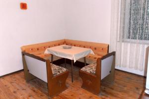 a table and chairs in a room with a table and a table and chairs at Apartments with parking space Vrisnik, Hvar - 4051 in Jelsa