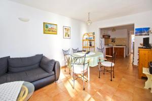 a living room with a couch and a table and chairs at Seaside secluded apartments Cove Tvrdni Dolac, Hvar - 4008 in Gdinj