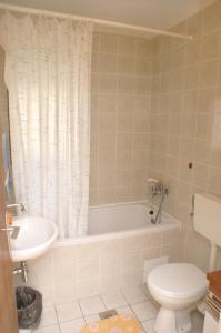 a bathroom with a tub and a toilet and a sink at Apartments by the sea Sepurine, Prvic - 4238 in Prvić Šepurine +16 photos