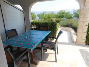 a blue table and chairs on a patio at Apartments by the sea Slatine, Ciovo - 1128 in Slatine