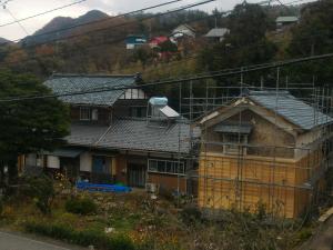 una casa en construcción al lado de una colina en Echizen Guesthouse TAMADA en Fukui