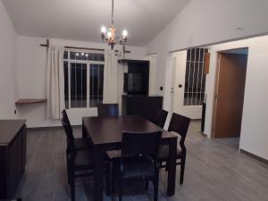 a dining room and kitchen with a table and chairs at Hermosos departamentos en el centro de Coatepec Veracruz in Coatepec +18 photos
