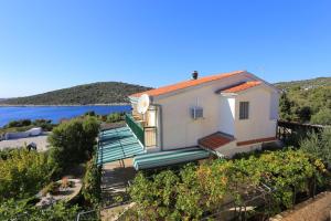 a house with a balcony with a view of the water at Apartments by the sea Sevid, Trogir - 2044 in Sevid